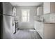 Updated kitchen with stainless steel refrigerator, white cabinets, and subway tile backsplash at 921 Grand Central St, Clearwater, FL 33756