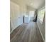 Bright laundry area with washer, dryer, and water heater near door and windows at 921 Grand Central St, Clearwater, FL 33756