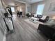 Bright, airy living room with modern furnishings and wood-look flooring leading to dining area at 921 Grand Central St, Clearwater, FL 33756