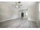 Bright living room featuring modern gray flooring and a ceiling fan for added comfort at 921 Grand Central St, Clearwater, FL 33756