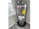 Modern water heater with energy guide and connections in laundry area at 921 Grand Central St, Clearwater, FL 33756