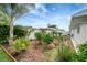 Backyard with tropical garden and white fence at 9619 Towanda Ln, Port Richey, FL 34668