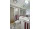 Compact bathroom with a tiled shower, toilet, single sink, and modern fixtures at 9619 Towanda Ln, Port Richey, FL 34668
