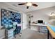 Functional craft room featuring a ceiling fan, and multiple workspaces with storage for organization at 9619 Towanda Ln, Port Richey, FL 34668