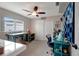Well-lit craft room with a ceiling fan, closet, and multiple workspaces for hobbies and organization at 9619 Towanda Ln, Port Richey, FL 34668