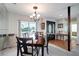 Elegant dining room featuring a chandelier and plenty of natural light at 9619 Towanda Ln, Port Richey, FL 34668