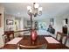 Dining room with view to living room and sliding glass door to outdoor patio at 9619 Towanda Ln, Port Richey, FL 34668