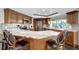Gourmet kitchen features granite countertops, stainless steel appliances, wood cabinetry, and a large island at 9619 Towanda Ln, Port Richey, FL 34668