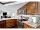 Gourmet kitchen features granite countertops, stainless steel appliances and custom wood cabinetry at 9619 Towanda Ln, Port Richey, FL 34668