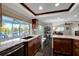 Beautiful kitchen with wood cabinets, granite counters, and a large window overlooking the pool at 9619 Towanda Ln, Port Richey, FL 34668