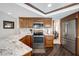 Modern kitchen featuring stainless steel appliances, granite counters, and wood cabinetry at 9619 Towanda Ln, Port Richey, FL 34668