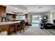 Open kitchen and living room area with island, bar seating, and view of the pool at 9619 Towanda Ln, Port Richey, FL 34668