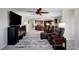 A spacious living room with recliners and open layout, leading to an open-concept kitchen with a breakfast bar at 9619 Towanda Ln, Port Richey, FL 34668