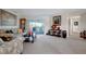 Bright living room with sofa, chairs, grandfather clock and sliding glass doors to patio at 9619 Towanda Ln, Port Richey, FL 34668