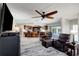 A large living room with furniture facing an open kitchen and breakfast bar, creating a connected living space at 9619 Towanda Ln, Port Richey, FL 34668