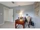 Well-lit home office featuring a wooden desk, patterned chair, and inspirational wall art at 9619 Towanda Ln, Port Richey, FL 34668