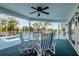 Covered patio with views of a pool, canal, and tropical landscaping; outdoor furniture at 9619 Towanda Ln, Port Richey, FL 34668