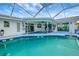 Enclosed pool with covered patio area and seating, perfect for outdoor entertaining and relaxation at 9619 Towanda Ln, Port Richey, FL 34668