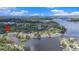 Waterfront home surrounded by lush greenery, showcasing private dock and tranquil waterfront living at 9938 Alavista Dr, Gibsonton, FL 33534
