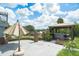 This backyard retreat features a beautiful gazebo with a hot tub, an umbrella covered patio and nice landscaping at 9938 Alavista Dr, Gibsonton, FL 33534