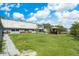 This backyard features ample green space, a gazebo with a hot tub, and a paved sidewalk circling the property at 9938 Alavista Dr, Gibsonton, FL 33534