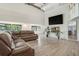 Spacious living room featuring modern fireplace, hardwood floors, and bright, natural light at 9938 Alavista Dr, Gibsonton, FL 33534