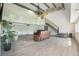 Open living room with light wood flooring, neutral walls, vaulted ceilings and exposed beams at 9938 Alavista Dr, Gibsonton, FL 33534