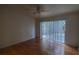 Spacious bedroom with hardwood floors and a sliding glass door leading to the backyard at 10024 Cedar Dune Dr, Tampa, FL 33624