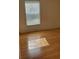Cozy bedroom with hardwood floors and a window with blinds at 10024 Cedar Dune Dr, Tampa, FL 33624