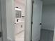 View of the bathroom featuring new marble floors and vanity with black hardware at 1005 S Empire St, Plant City, FL 33563