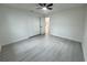 A bedroom featuring wood-look flooring, a ceiling fan, and a large closet at 1005 S Empire St, Plant City, FL 33563
