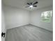Bright bedroom with a modern ceiling fan and gray wood-look flooring at 1005 S Empire St, Plant City, FL 33563