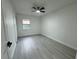 Bright bedroom featuring wood-look floors, a window, and closet at 1005 S Empire St, Plant City, FL 33563