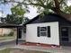 Charming home featuring a black and white exterior and neatly landscaped front yard at 1005 S Empire St, Plant City, FL 33563