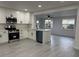 Stylish kitchen with white cabinets, stainless steel appliances, and an open layout to the living area at 1005 S Empire St, Plant City, FL 33563