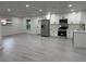 Contemporary open-concept kitchen featuring white cabinets, and stainless steel appliances at 1005 S Empire St, Plant City, FL 33563