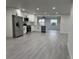 Kitchen featuring white cabinetry, stainless steel appliances, and a seamless transition to the living space at 1005 S Empire St, Plant City, FL 33563