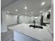 Open-concept kitchen featuring a white quartz countertop and breakfast bar overlooking the living area at 1005 S Empire St, Plant City, FL 33563