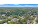 Expansive aerial shot of a residential neighborhood with lush greenery and a mix of homes among mature trees at 1010 E Fern St, Tampa, FL 33604