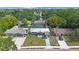 Aerial view of a charming home nestled in a lush, green neighborhood with mature trees and well-maintained landscaping at 1010 E Fern St, Tampa, FL 33604