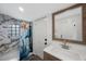 This bathroom boasts a modern vanity, stylish mirror, and a shower enclosed with attractive tile at 1010 E Fern St, Tampa, FL 33604