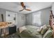 Cozy bedroom with a ceiling fan, window, and decorative furnishings, showcasing natural light at 1010 E Fern St, Tampa, FL 33604