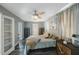 Spacious bedroom with calming colors, wood-look floors and a view to additional living spaces at 1010 E Fern St, Tampa, FL 33604