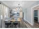 Cozy dining room area with open views of the modern kitchen and an adjacent sun-filled window at 1010 E Fern St, Tampa, FL 33604