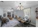 Open-concept dining room featuring a decorative light fixture and hardwood flooring at 1010 E Fern St, Tampa, FL 33604