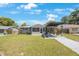 Charming home featuring a well-manicured lawn, inviting front porch, and a stylish carport for convenience at 1010 E Fern St, Tampa, FL 33604