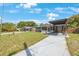 Single-story home with a well-maintained front yard and covered driveway that provides ample space for parking at 1010 E Fern St, Tampa, FL 33604