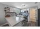 Modern kitchen boasts stainless steel appliances, unique backsplash, and spacious concrete countertops at 1010 E Fern St, Tampa, FL 33604
