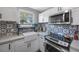 Close-up of a modern kitchen featuring stainless steel appliances and patterned backsplash at 1010 E Fern St, Tampa, FL 33604