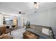 Open-concept living room with stylish furniture, a ceiling fan, and a view of the adjacent dining area and kitchen at 1010 E Fern St, Tampa, FL 33604